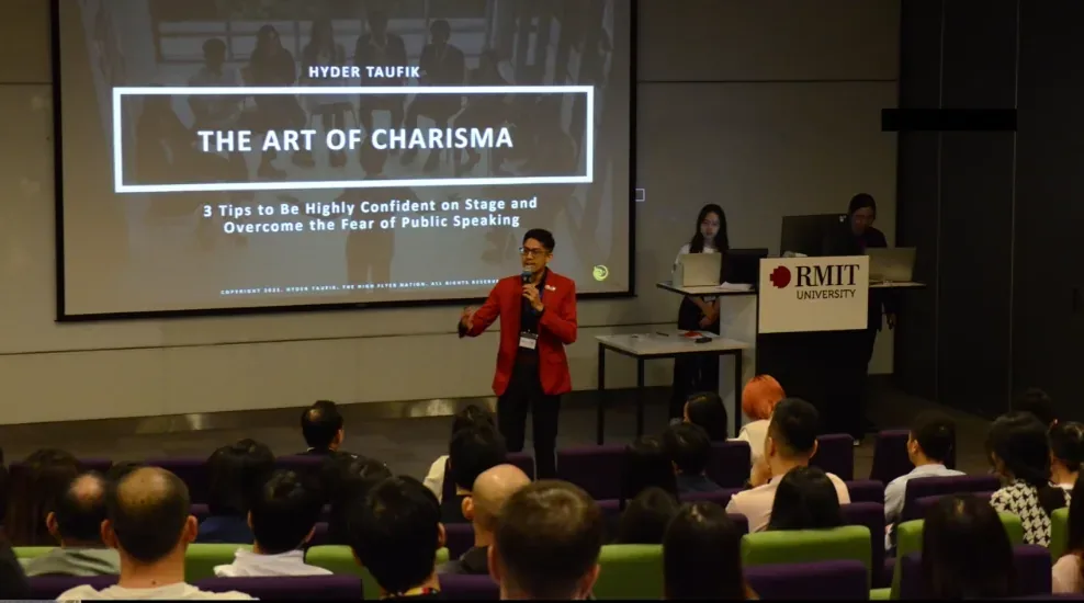 Hyder Taufik on stage delivering The Art of Charisma at RMIT University